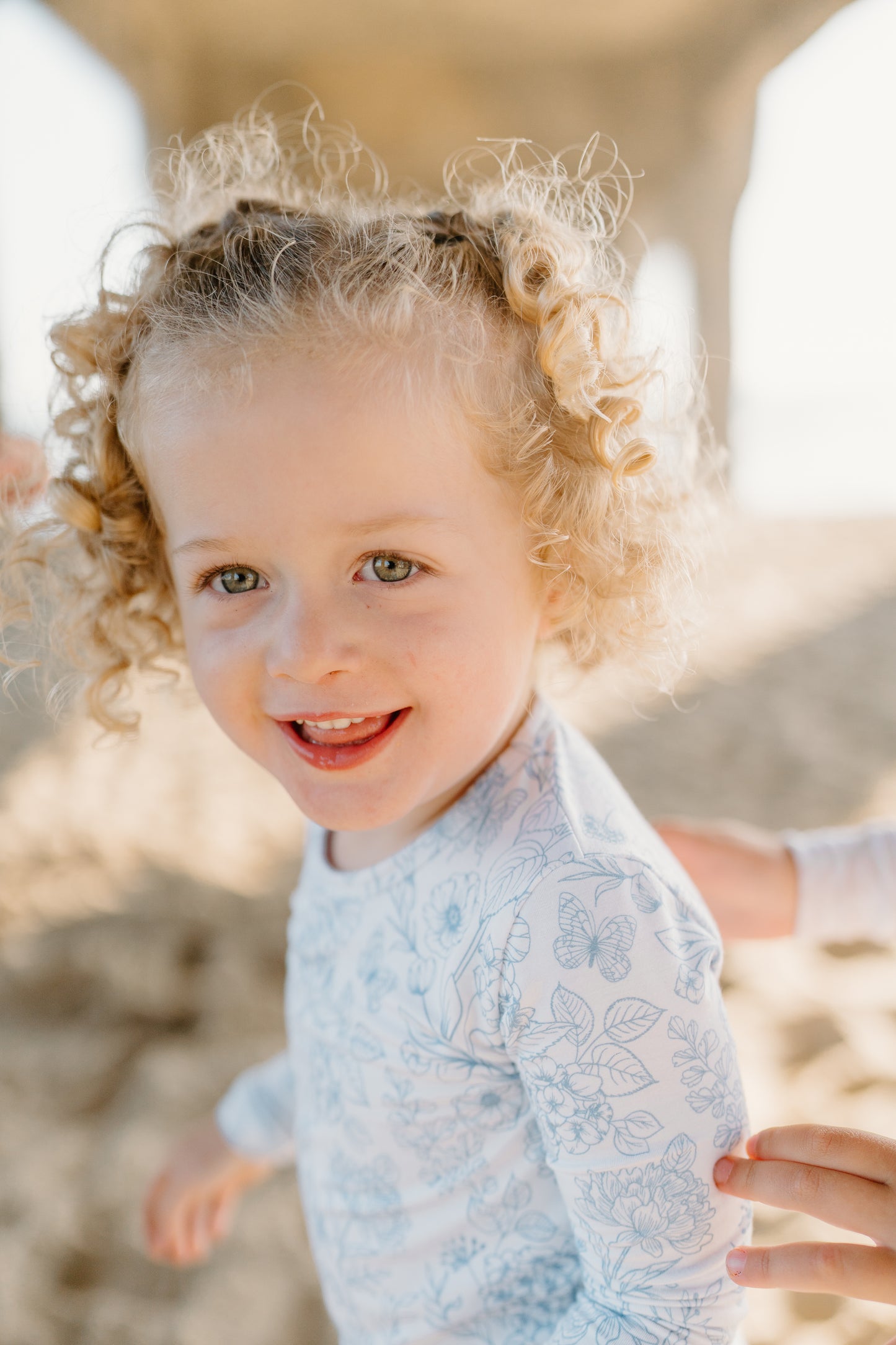 Eco-friendly bamboo baby romper with a delicate blue floral design, buttery-soft bamboo fabric, and double-zipper closure by Shae & Palmer.