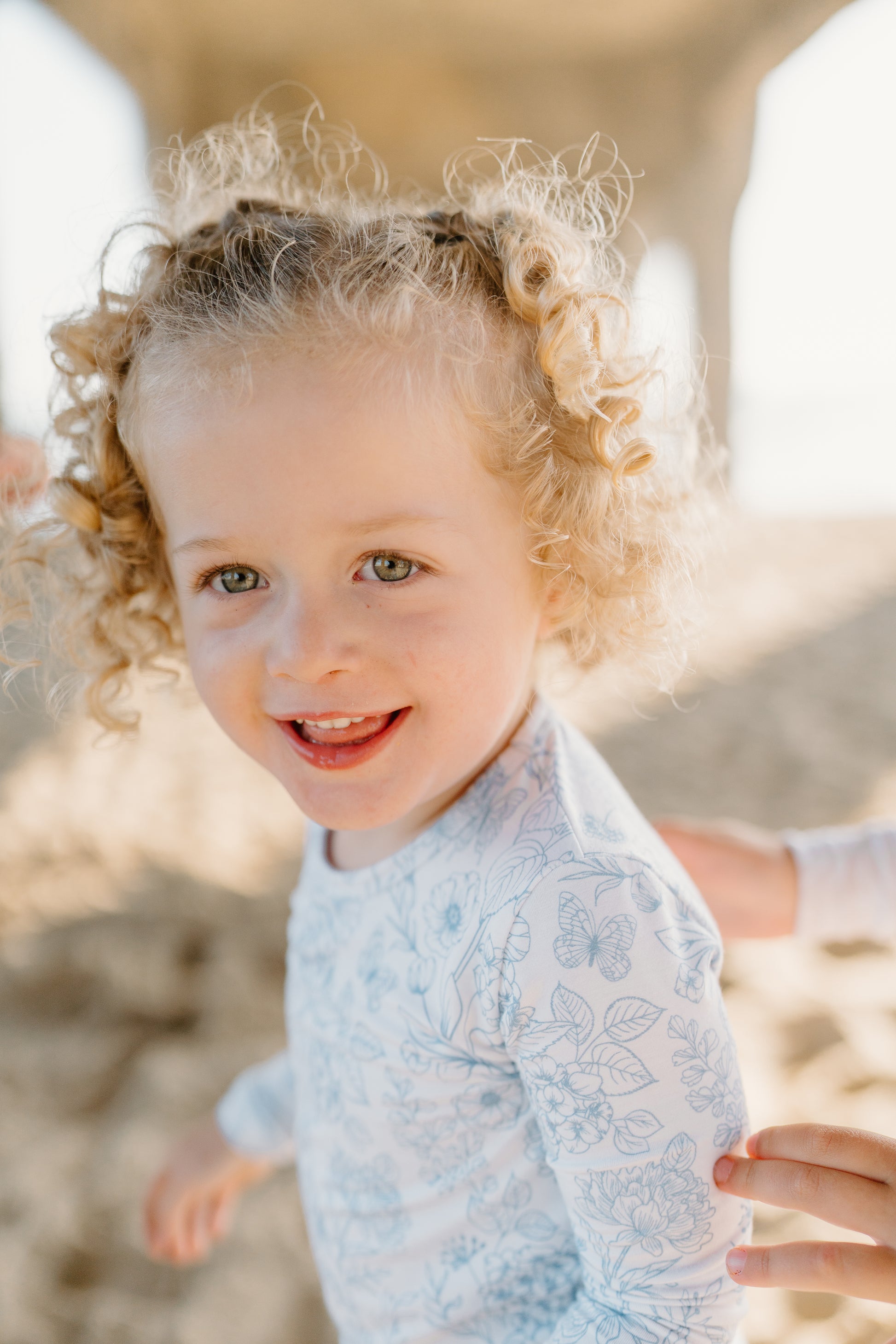 Eco-friendly bamboo baby romper with a delicate blue floral design, buttery-soft bamboo fabric, and double-zipper closure by Shae & Palmer.