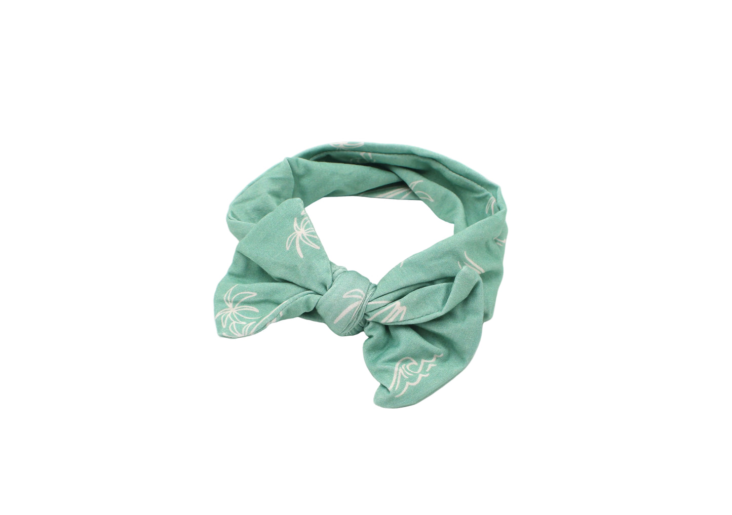 Close-up of baby wearing Shae & Palmer Surfside Dreams bamboo headband featuring palm tree, surfboard, and wave coastal print