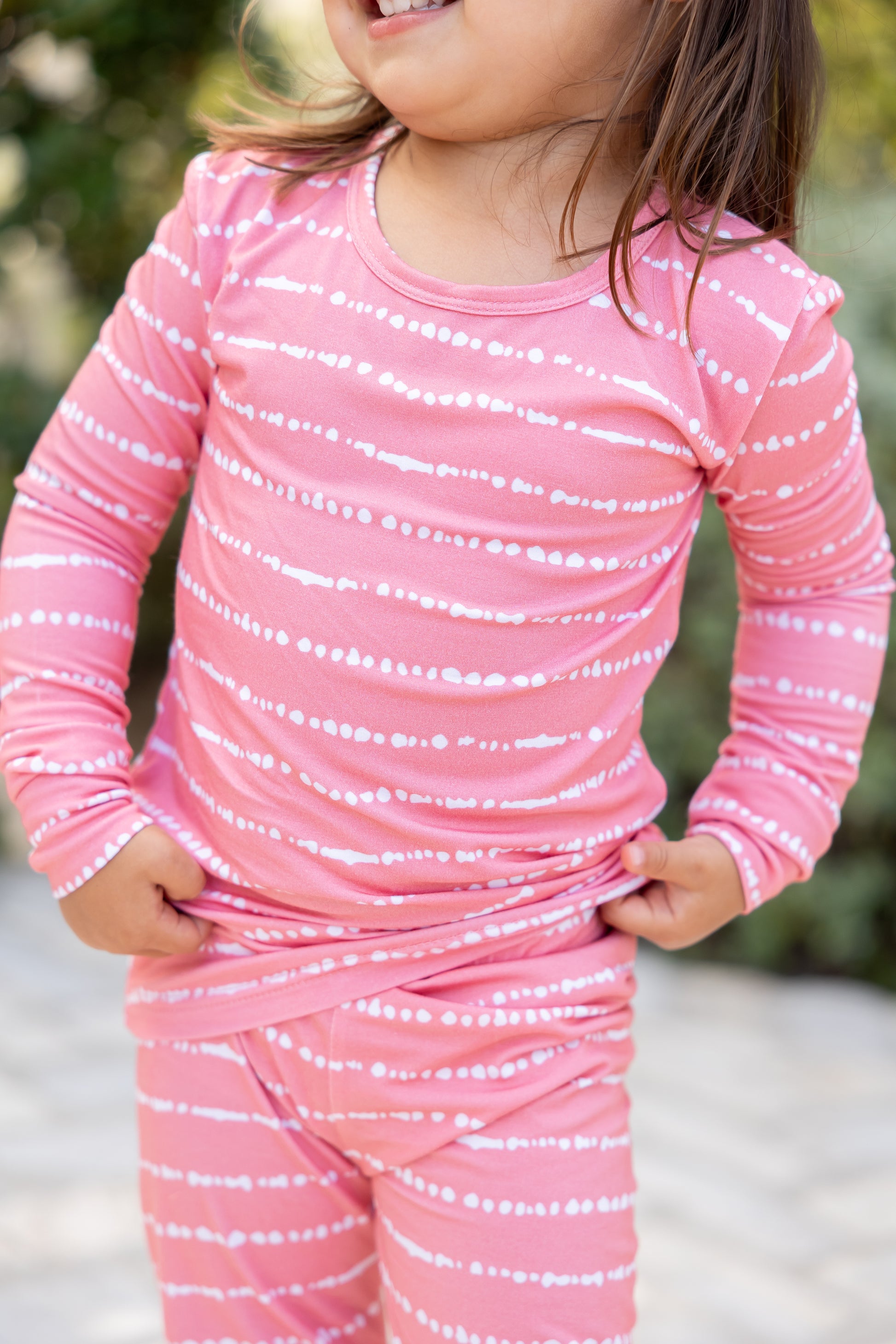 Close-up of toddler in Watermelon Blush Stripe bamboo pajama set, soft and breathable fabric