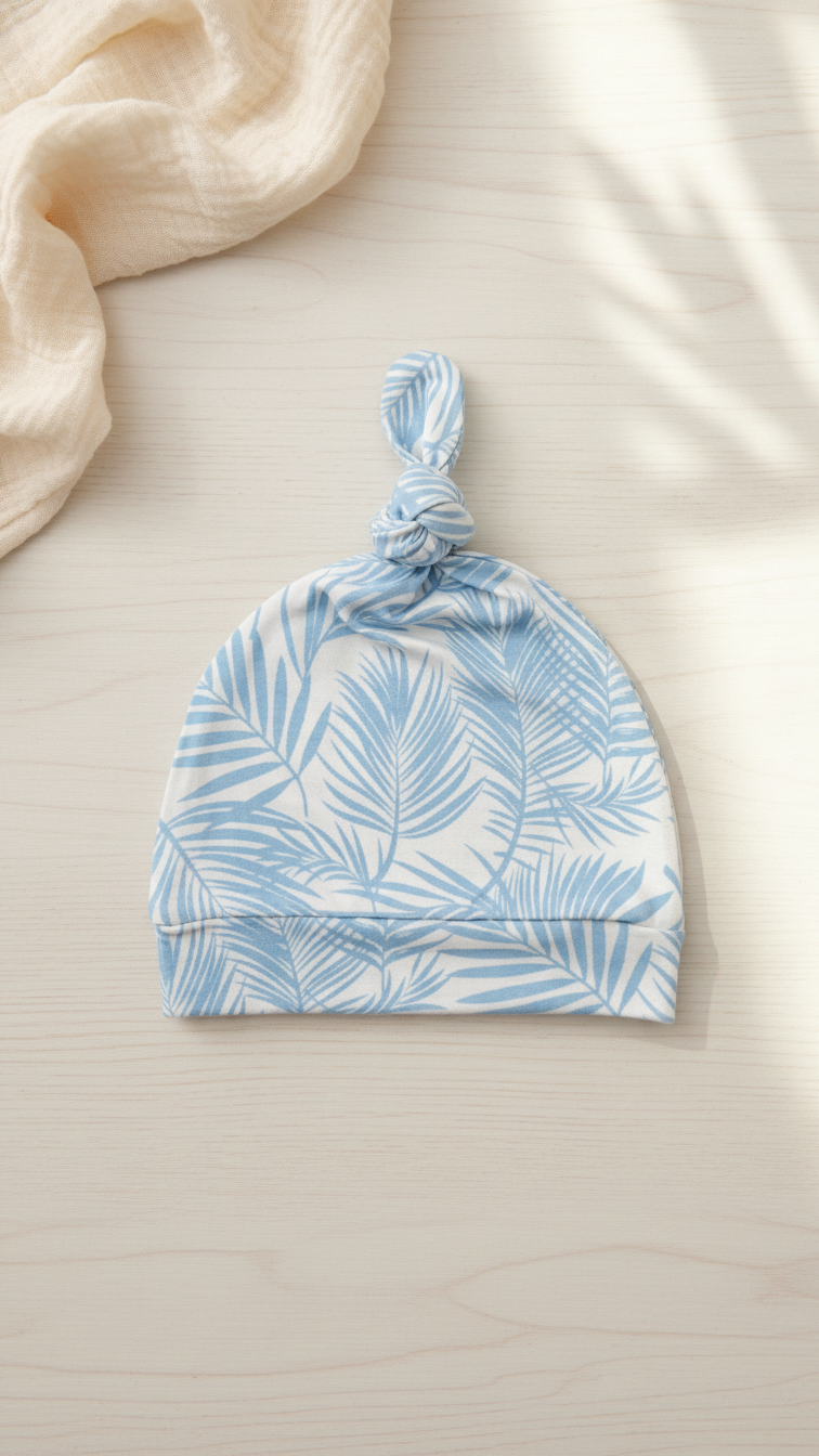 Ultra soft bamboo baby hat in baby blue palm leaf print from Shae & Palmer Cali Coastal collection, cozy breathable newborn essential