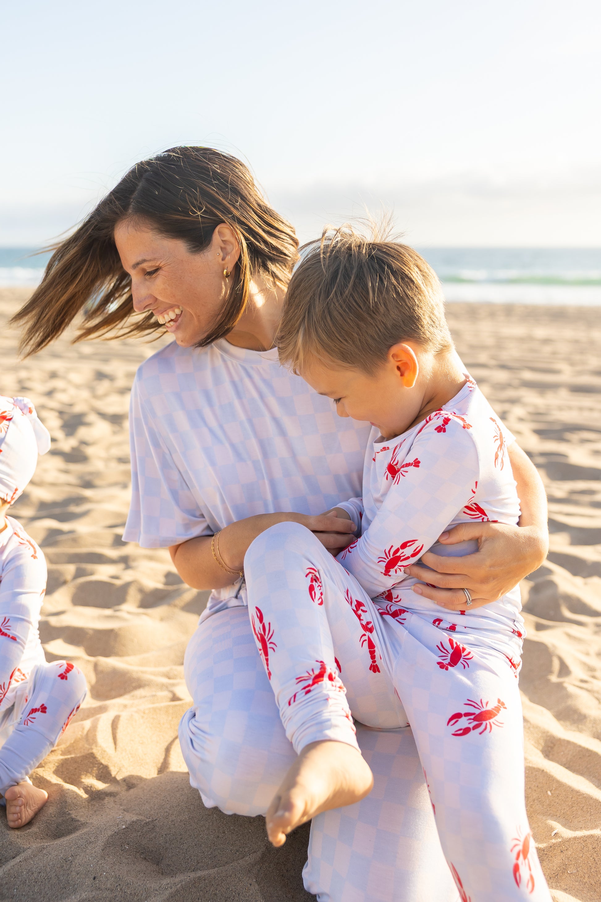 Women’s Checkered Splash blue bamboo pajamas by Shae & Palmer featuring a playful coastal-inspired checker print perfect for matching family moments.