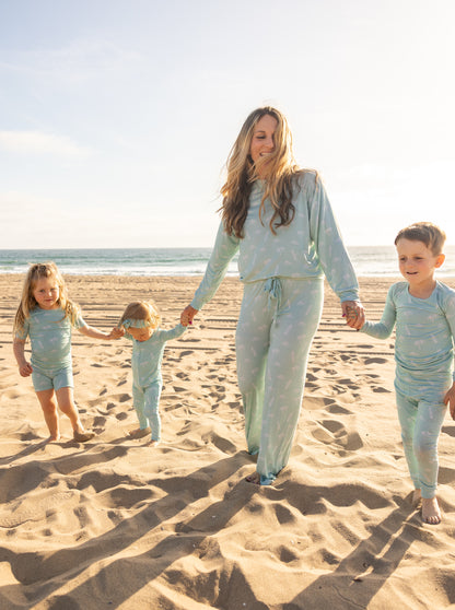 Family matching moment in the Surfside Dream collection by Shae & Palmer featuring coordinated coastal-inspired bamboo pajamas for moms, babies, and kids.