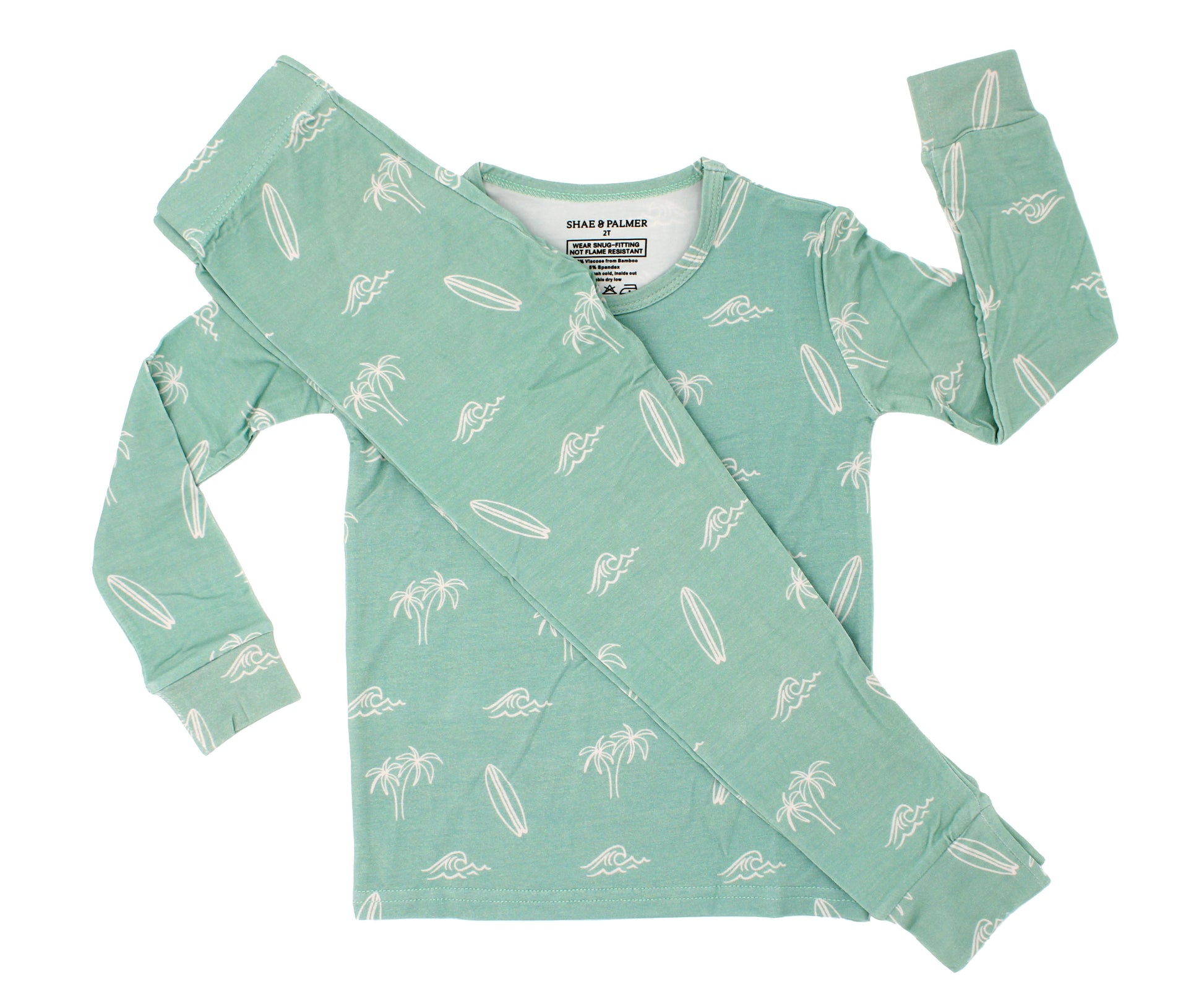 Flat lay of the Surfside Dreams kids bamboo pajama set by Shae & Palmer featuring a soft coastal print with surfboards, palm trees, and ocean-inspired details.