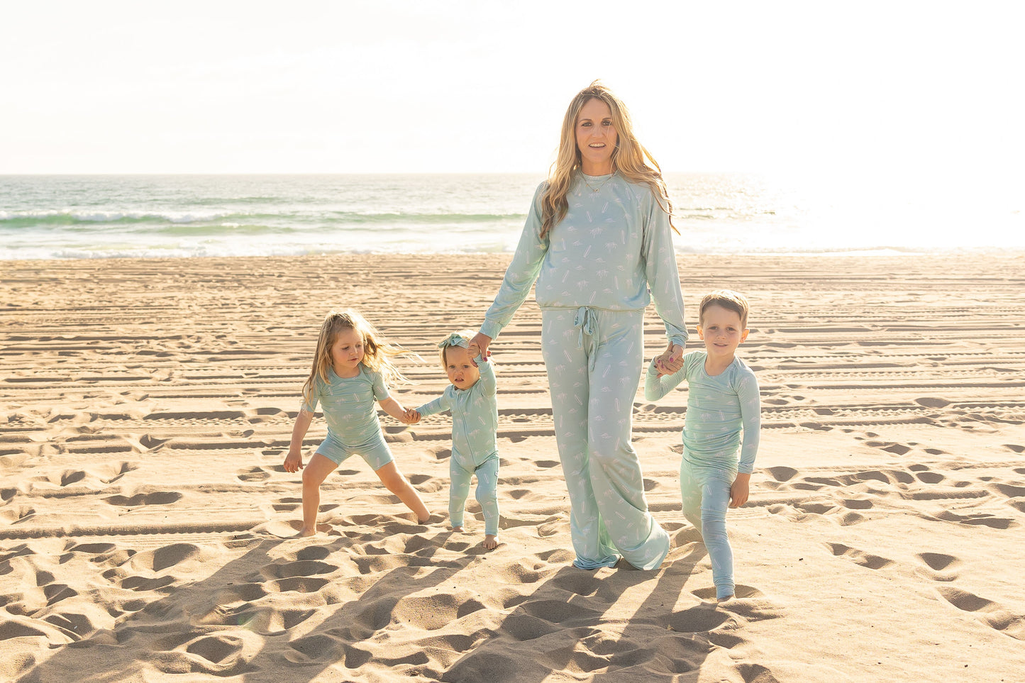 Matching family moment in the Surfside Dreams bamboo pajama collection by Shae & Palmer featuring coordinating coastal-inspired sleepwear.