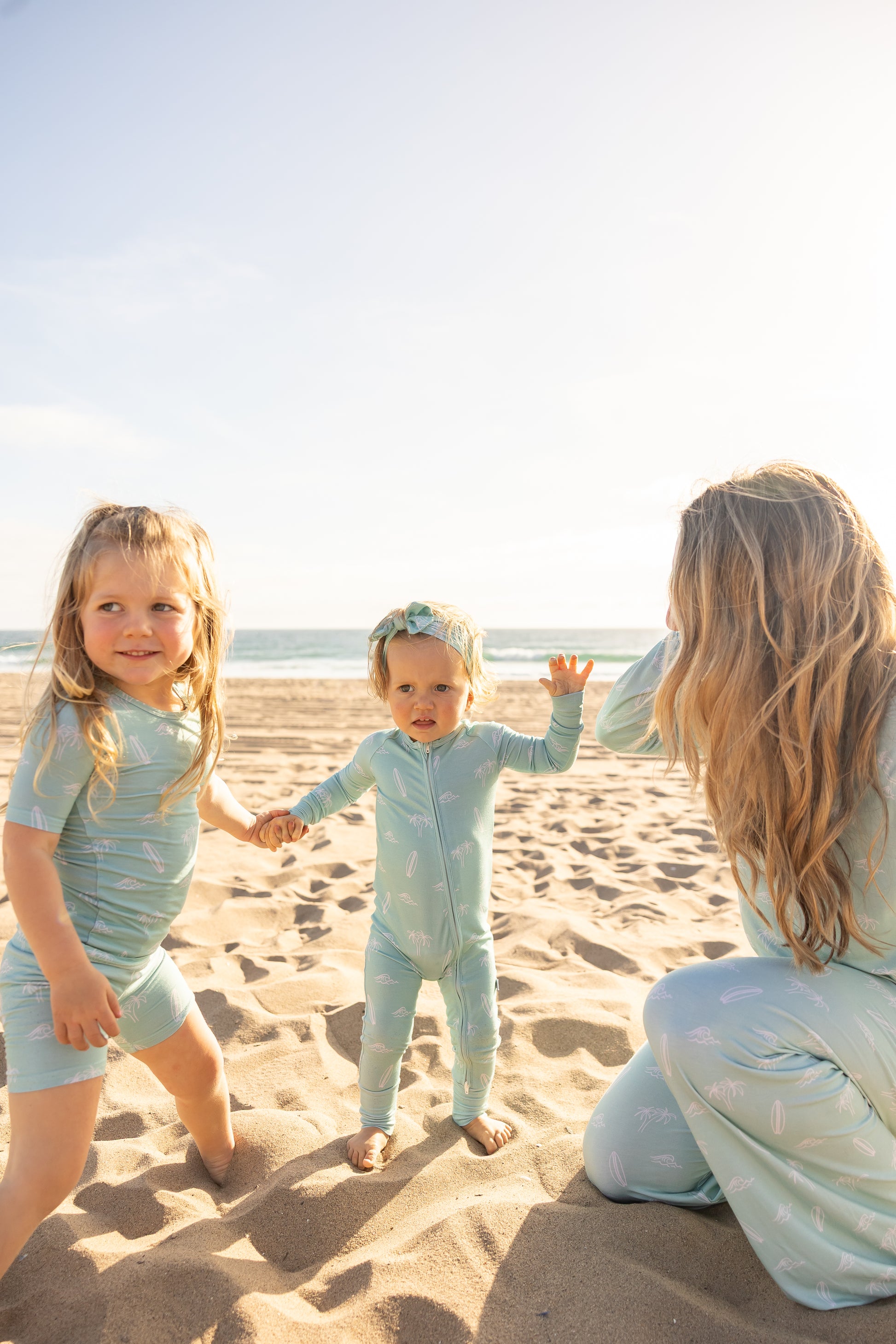 Family matching bamboo pajamas in the Surfside Dreams print by Shae & Palmer featuring a relaxed beach-inspired coastal design.