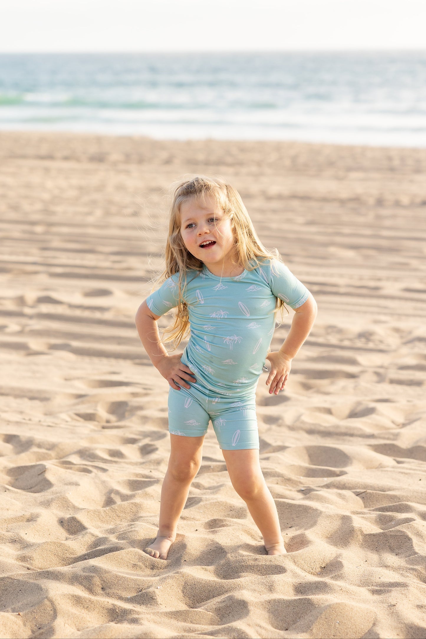 Surfside Dreams toddler bamboo pajama set by Shae & Palmer featuring surfboards and palm trees on a soft seafoam coastal print.