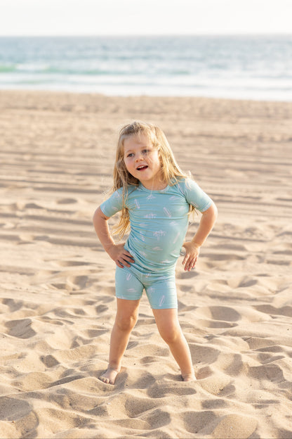Surfside Dreams toddler bamboo pajama set by Shae & Palmer featuring surfboards and palm trees on a soft seafoam coastal print.