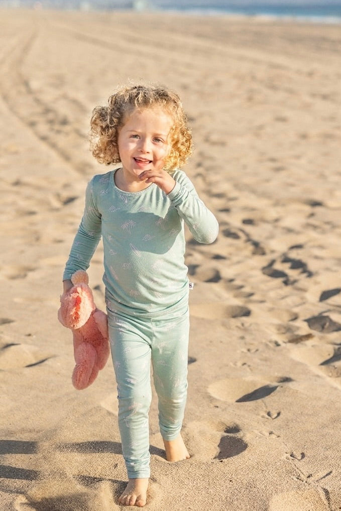 Surfside Dreams toddler bamboo pajama set by Shae & Palmer featuring surfboards, palm trees, and ocean-inspired details in soft seafoam hues.