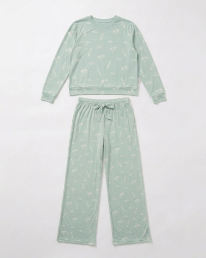 Flat lay of the Women’s Surfside Dreams bamboo pajama set by Shae & Palmer featuring a soft coastal print with surfboards, palm trees, and ocean-inspired details.