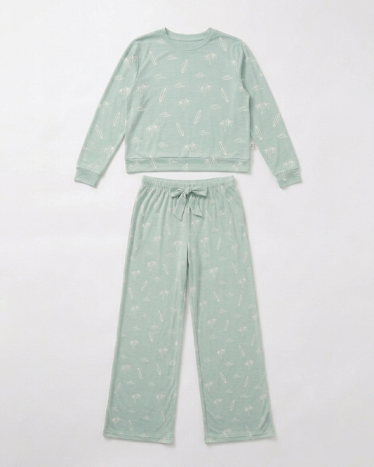 Flat lay of the Women’s Surfside Dreams bamboo pajama set by Shae & Palmer featuring a soft coastal print with surfboards, palm trees, and ocean-inspired details.