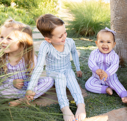 Toddler in Shae & Palmer Studio Stripe Green Haze bamboo pajamas featuring elevated hand-painted green stripes and temperature-regulating bamboo fabric for sleep and lounge comfort.