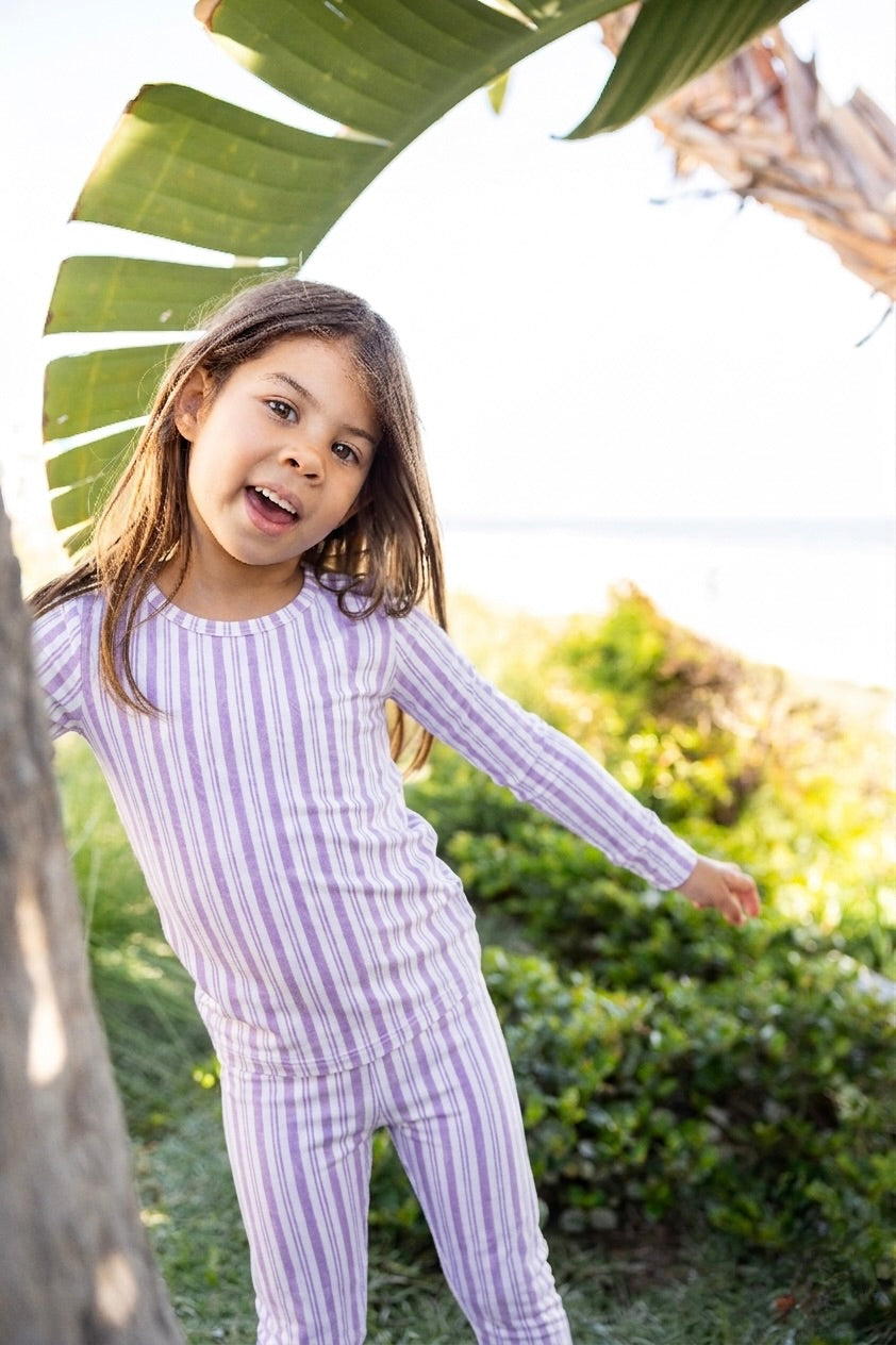 Big kid wearing Shae & Palmer Studio Stripe Purple Haze bamboo pajamas featuring muted purple painterly stripes and ultra-soft breathable bamboo fabric for cozy sleep and lounge comfort.