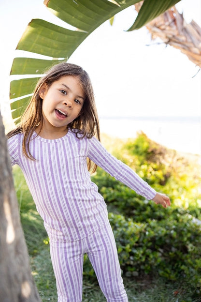 Big kid wearing Shae & Palmer Studio Stripe Purple Haze bamboo pajamas featuring muted purple painterly stripes and ultra-soft breathable bamboo fabric for cozy sleep and lounge comfort.