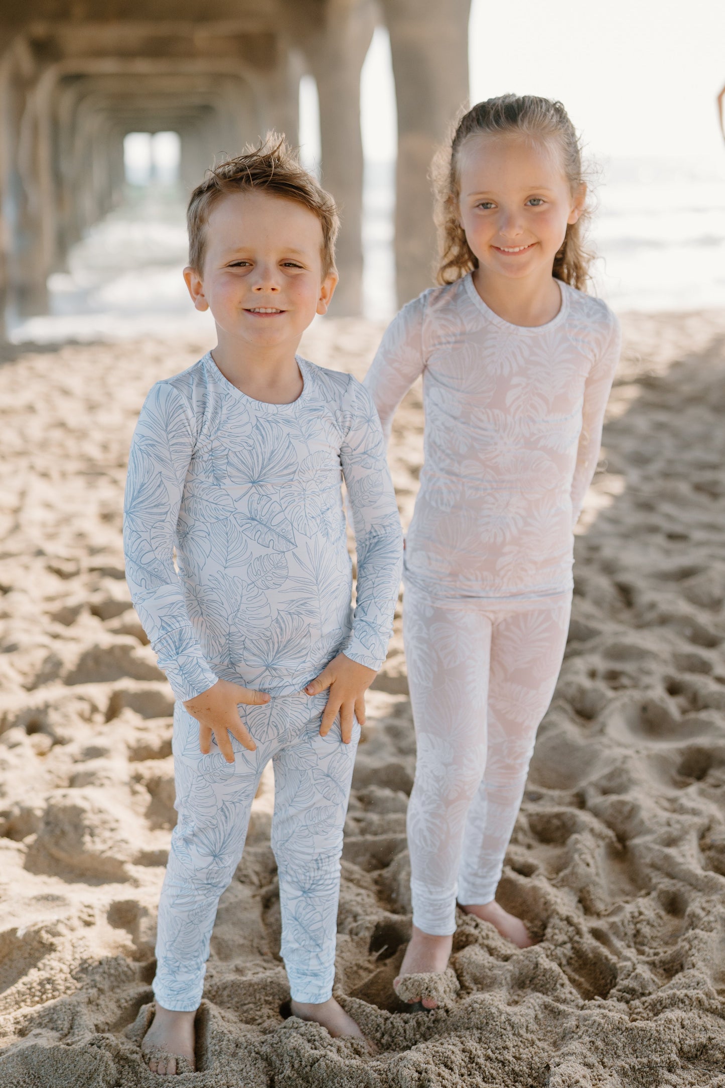 Shae & Palmer Tropical Bliss Collection, bamboo baby zip romper in Sandstone tropical floral print. Ultra-soft, breathable sleepwear with double zipper for easy diaper changes, perfect for baby girls in warmer weather