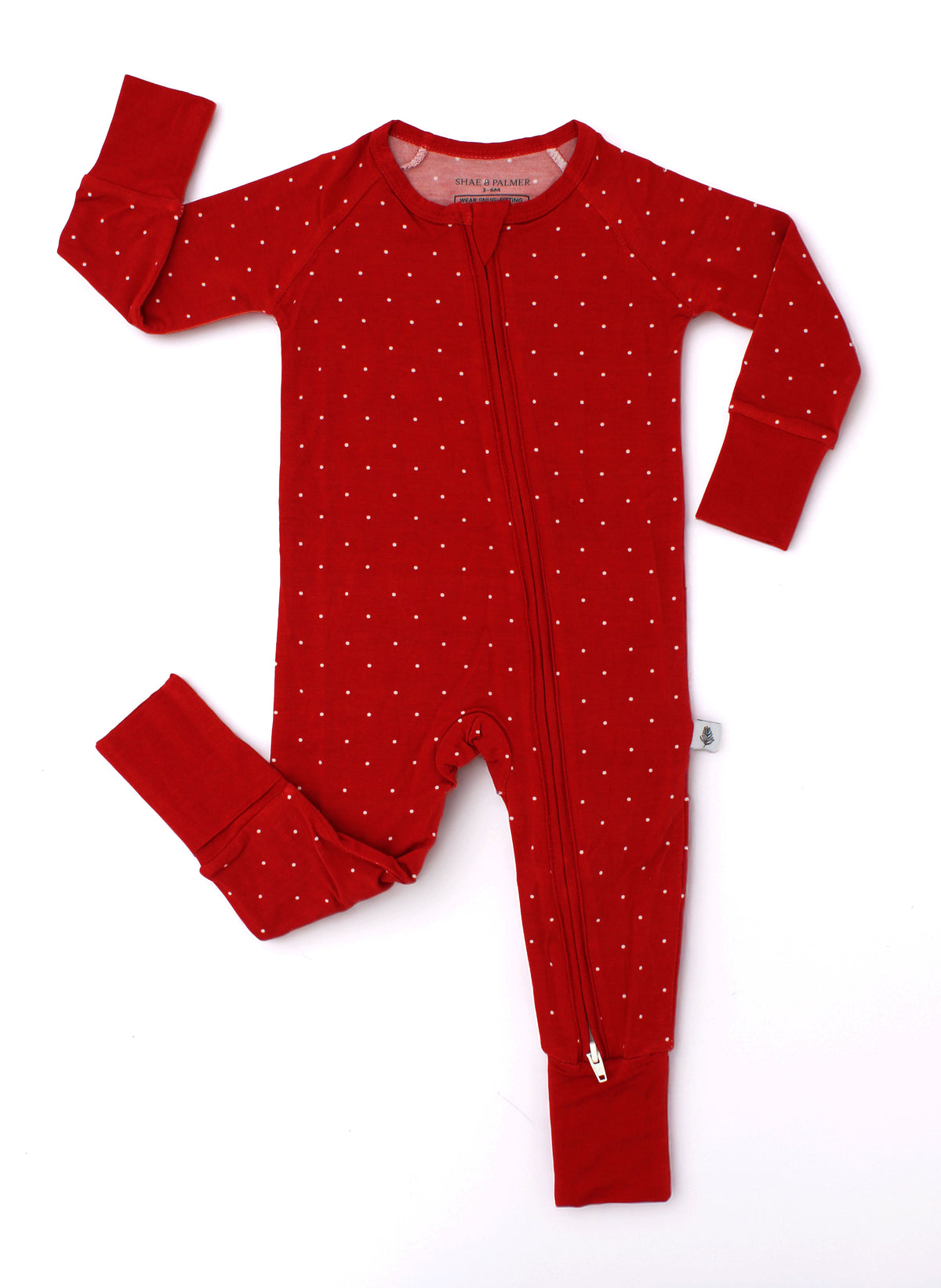 Dot Christmas baby romper by Shae & Palmer featuring a delicate red dot print on buttery-soft bamboo fabric. Festive red baby pajamas perfect for Christmas morning, holiday celebrations, and cozy winter nights. Family matching pjs