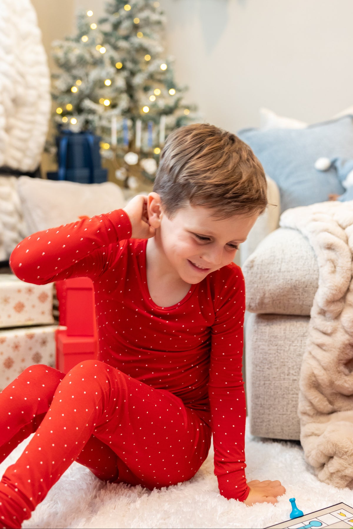 Kids wearing Ruby Dot bamboo pajamas by Shae & Palmer featuring a festive red polka dot print. Soft, breathable Christmas pajamas perfect for matching family holiday photos and cozy Christmas mornings.
