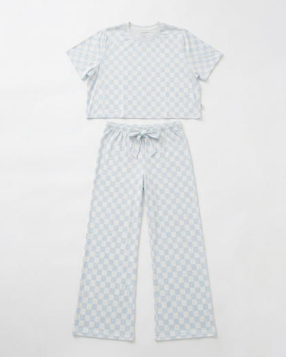 Woman wearing blue checkered bamboo pajama set with relaxed cropped top and matching pants front view