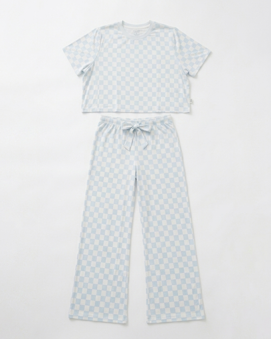 Woman wearing blue checkered bamboo pajama set with relaxed cropped top and matching pants front view