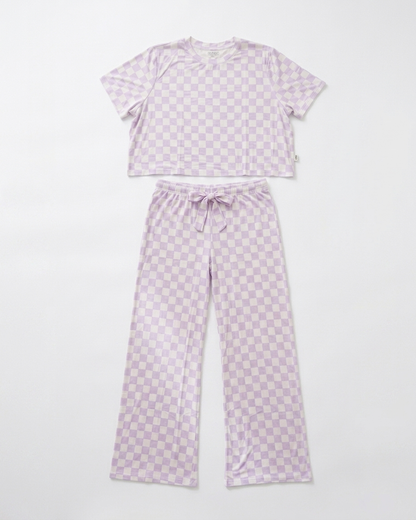 Woman wearing lavender checkered bamboo pajama set with relaxed cropped top and matching pants front view