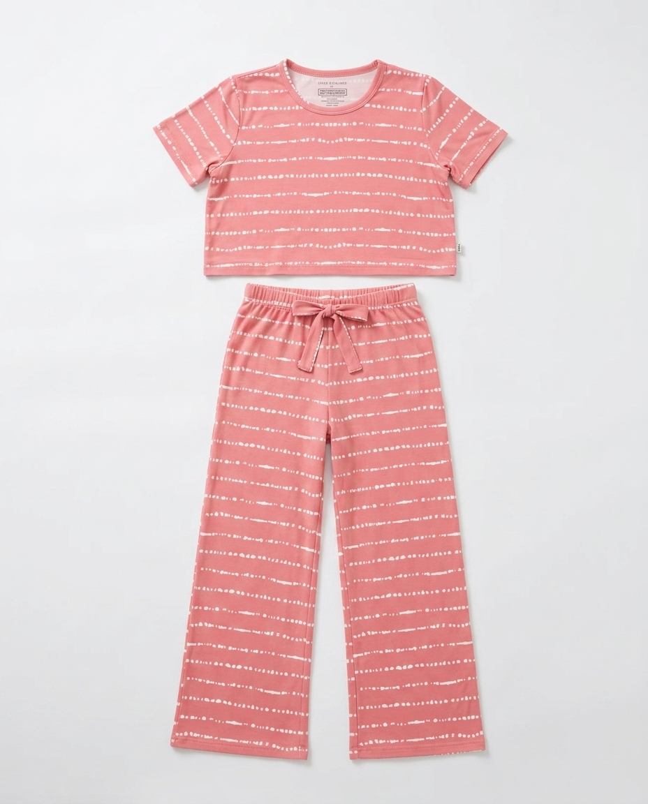 Flat lay of the Women's Watermelon Blush Stripe bamboo pajama set featuring a slightly cropped top and relaxed-fit pants with soft blush pink hand-painted stripes by Shae & Palmer.