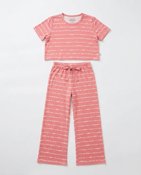 Flat lay of the Women's Watermelon Blush Stripe bamboo pajama set featuring a slightly cropped top and relaxed-fit pants with soft blush pink hand-painted stripes by Shae & Palmer.